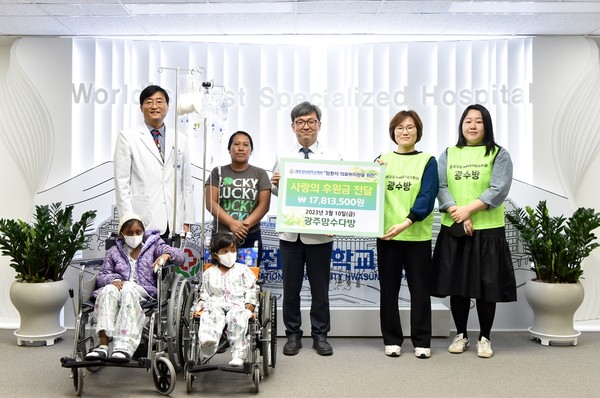 화순전남대학교 정용연 병원장(가운데)과 광주맘수다방 천미선 회장(오른쪽에서 두 번째) 등이 사랑의 후원금 전달 행사를 갖고 과테말라에서 수술과 치료를 위해 입원한 둘세 가족들과 함께 사진을 촬영하고 있다.